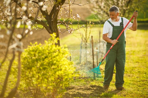 Crew demonstrating safe hedge trimming techniques with pruning tools